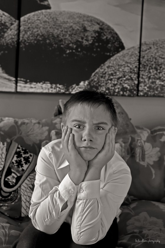 black and white portrait of boy scowling