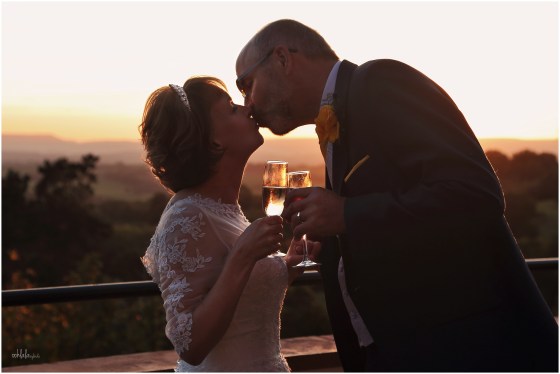 bride and groom kiss and toast just married at Caer Llan