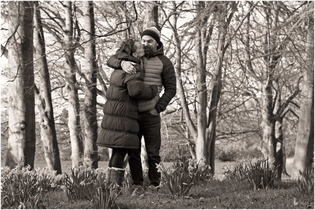 black and white portrait of couple kissing