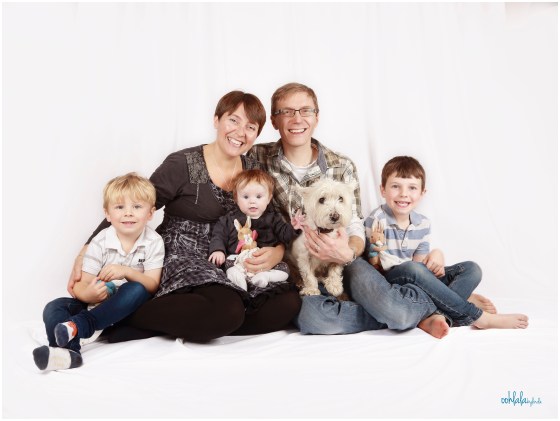 portrait of parents with three children and family dog