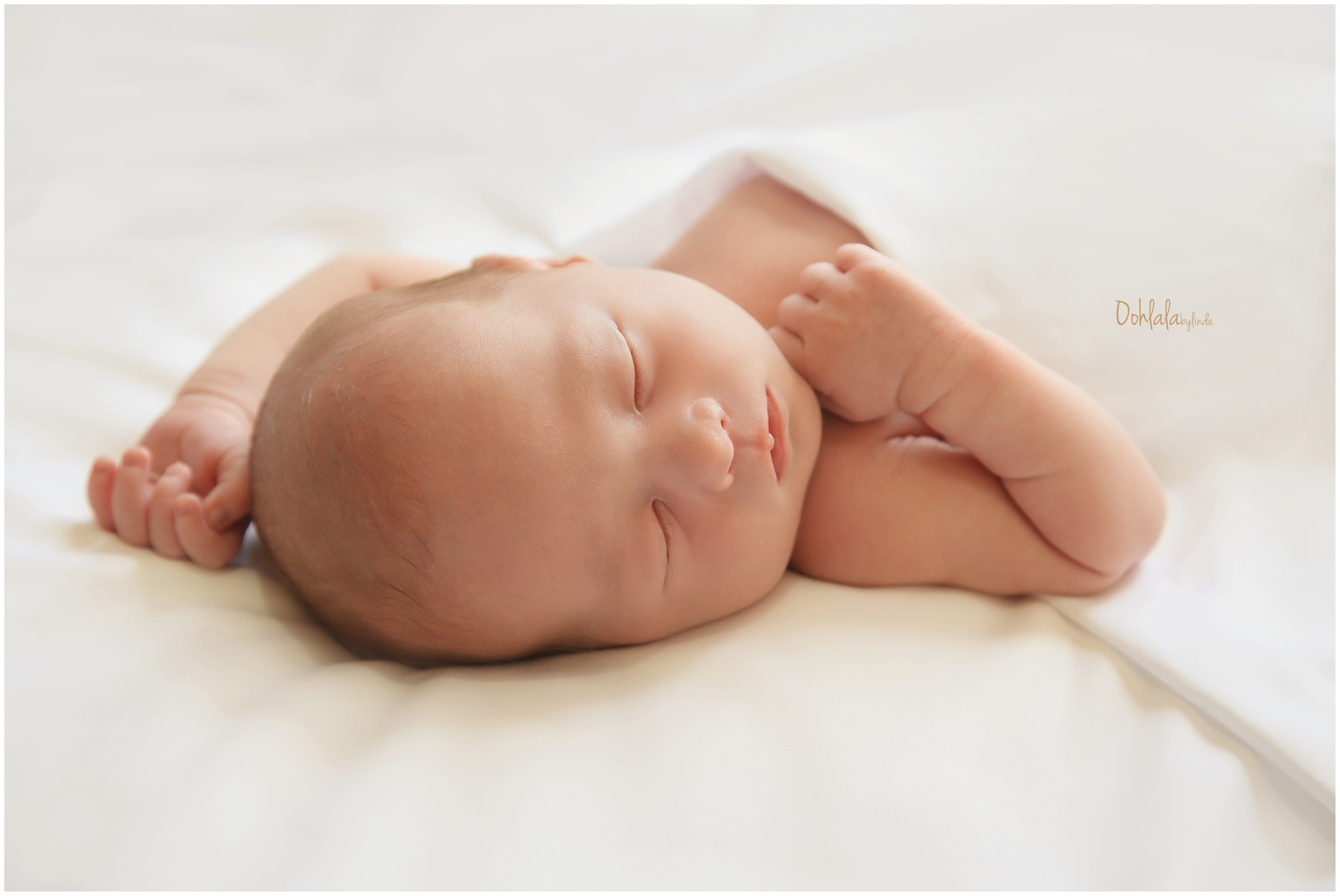 newborn baby sleeping on white background