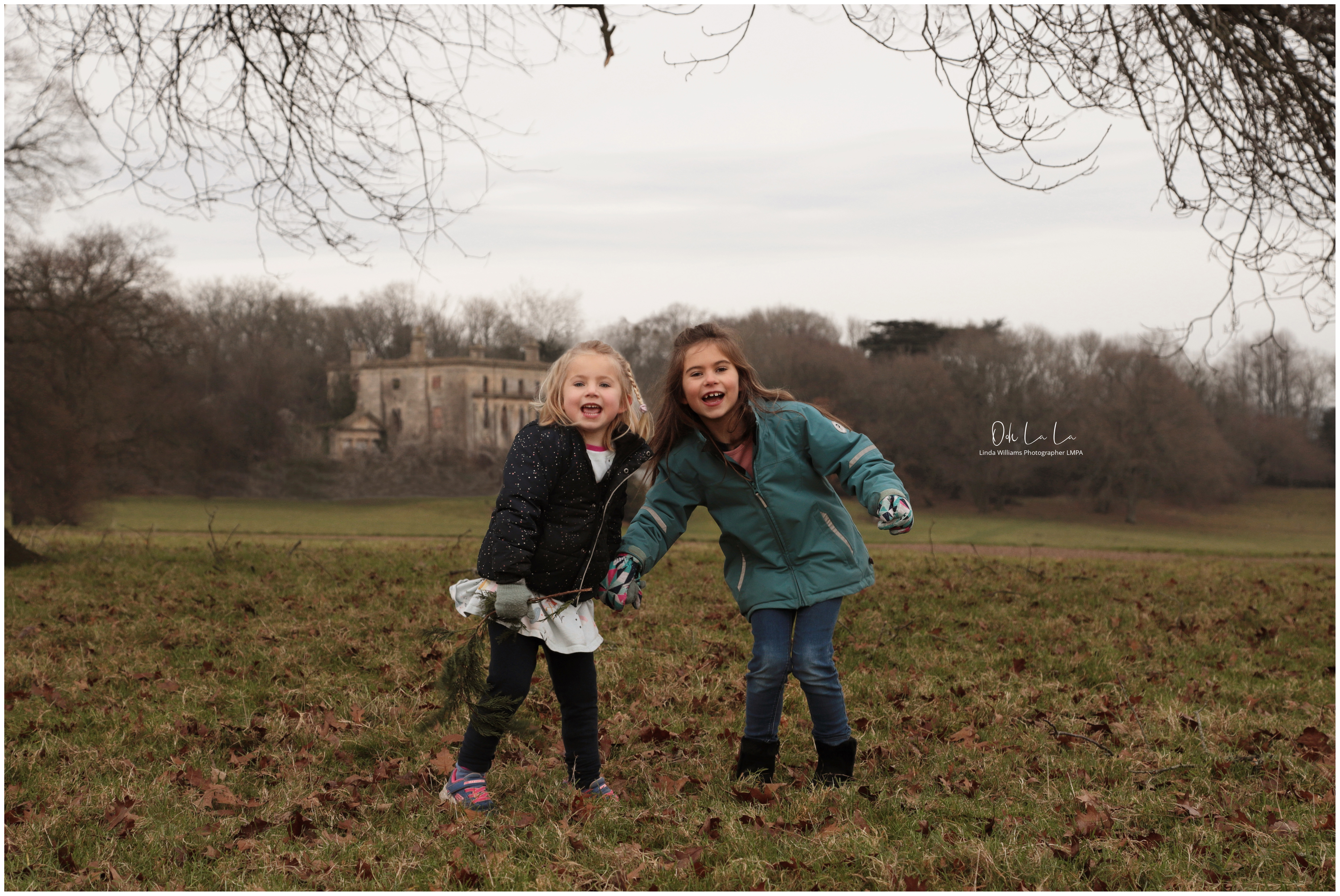 portrait of two little girls jumping in the park