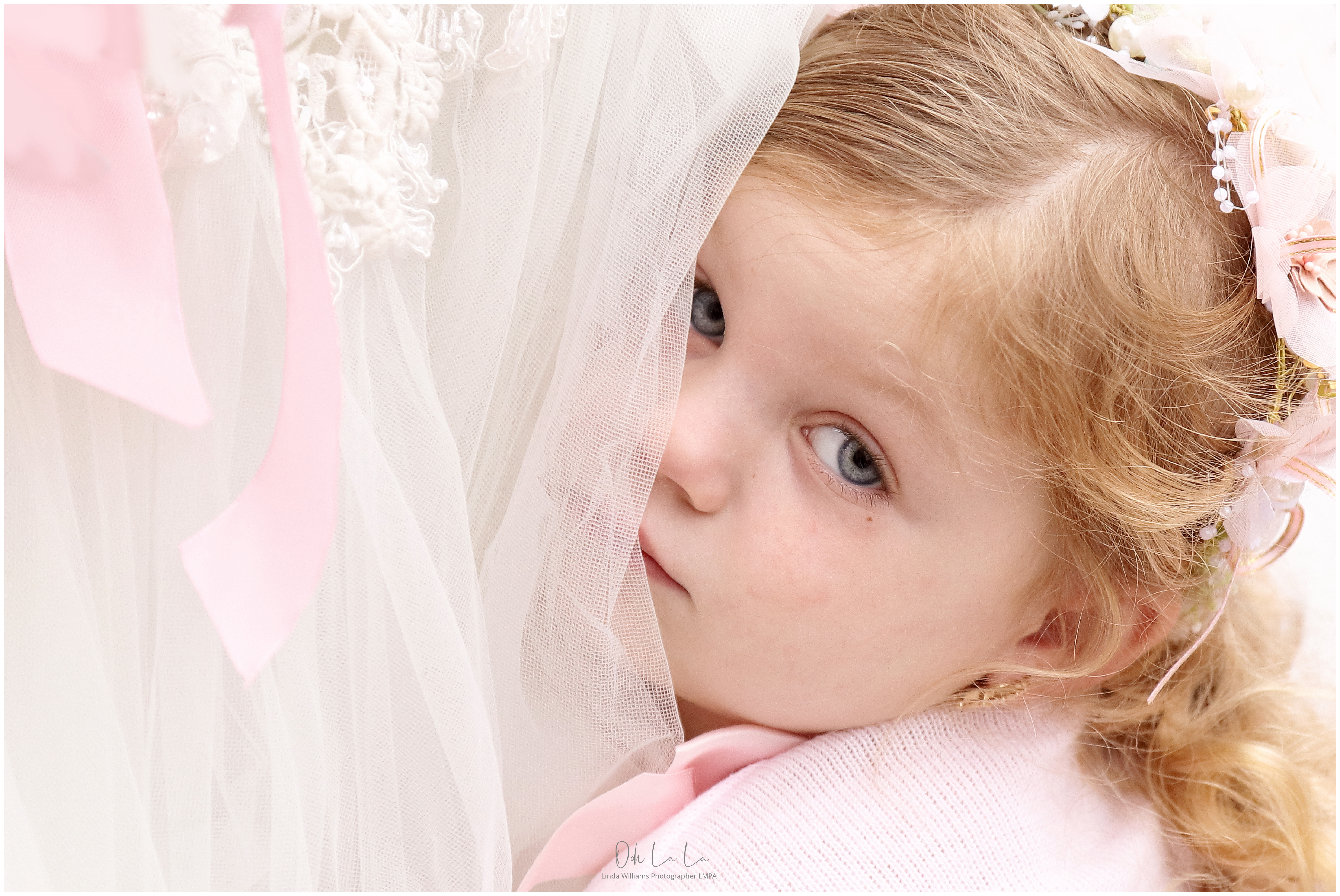little bridesmaid hiding in brides gown