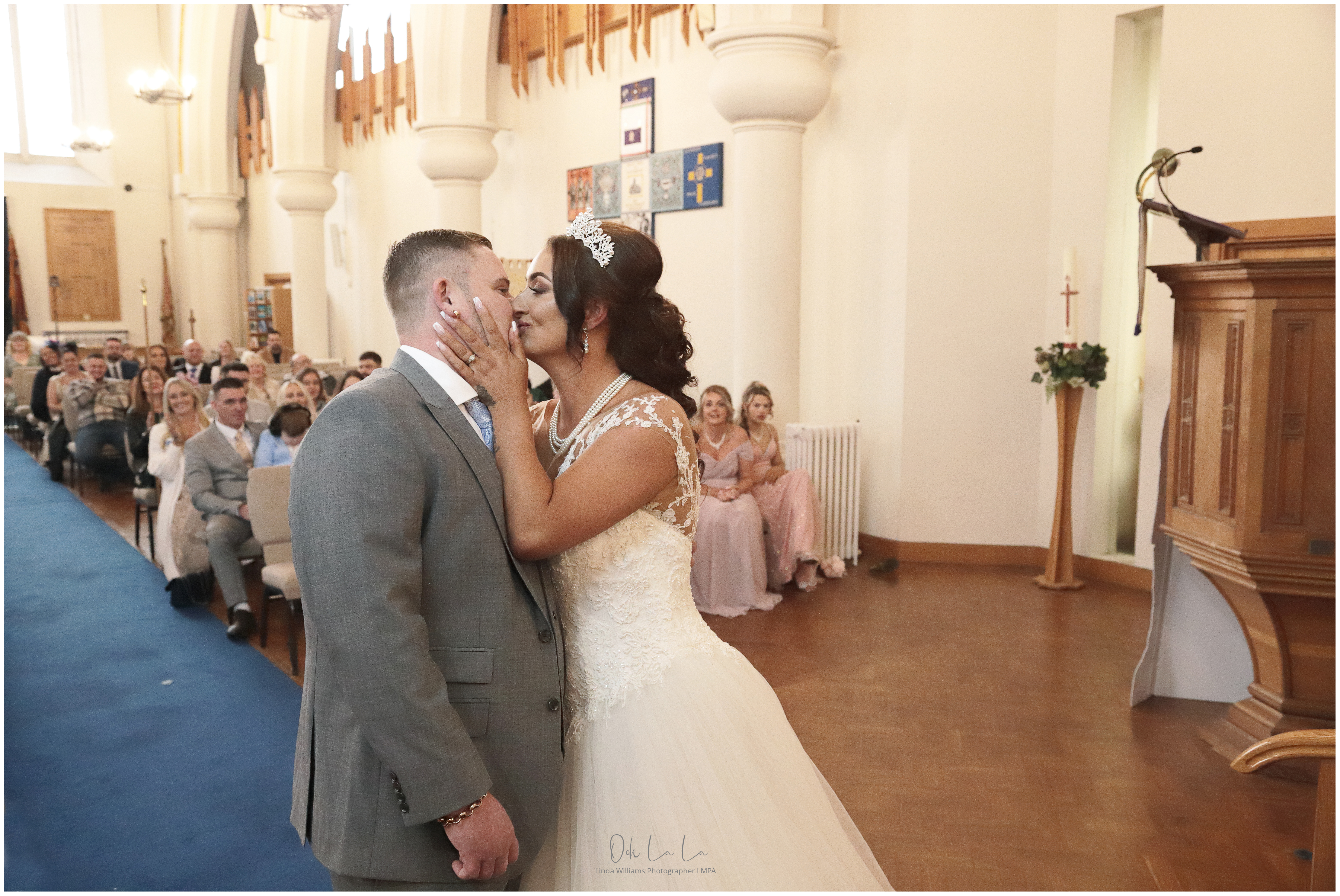bride and groom kissing at the altar