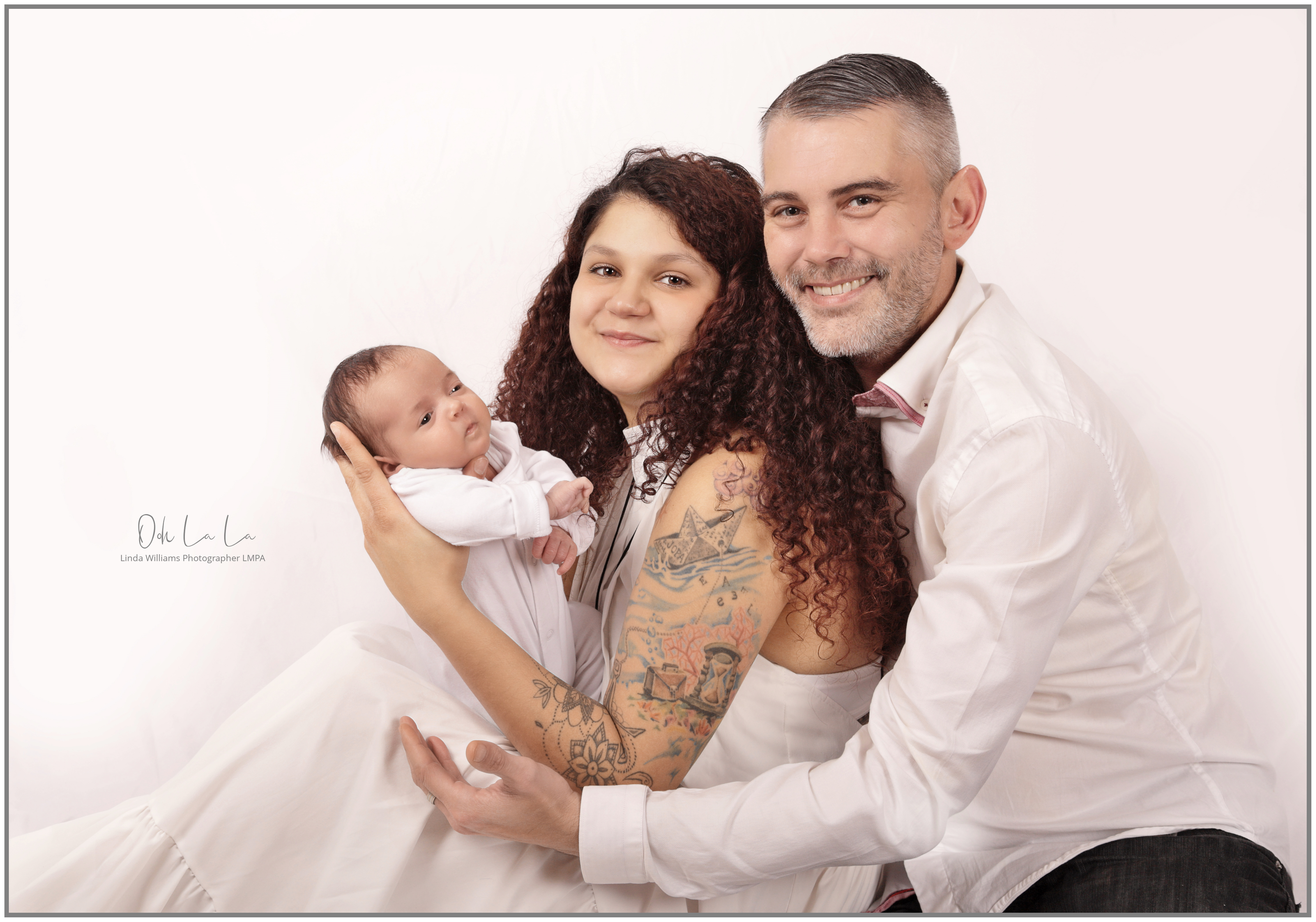 Young couple smiling with their new born baby boy