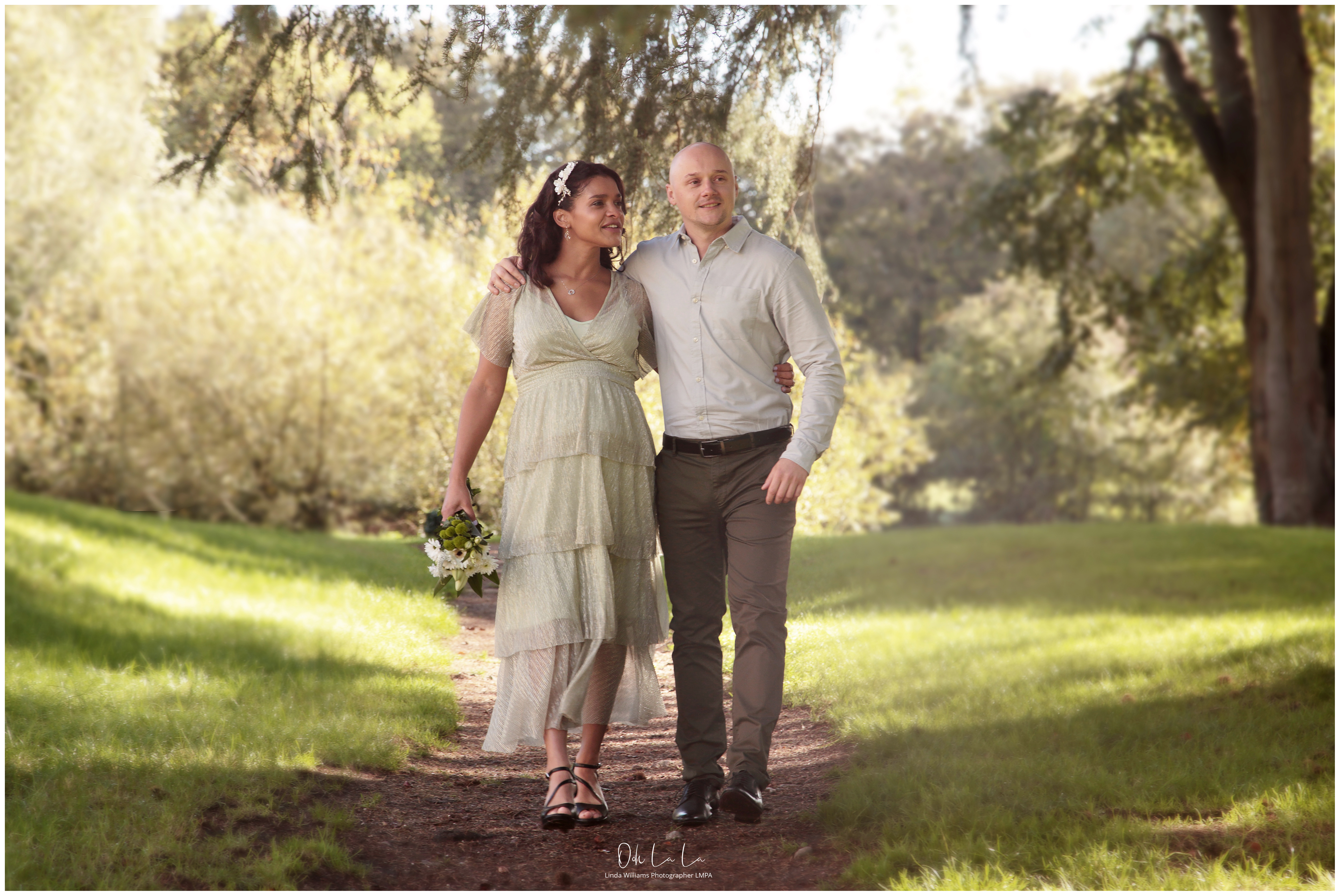 Bride and groom wlaking arm in arm at caldicot castle