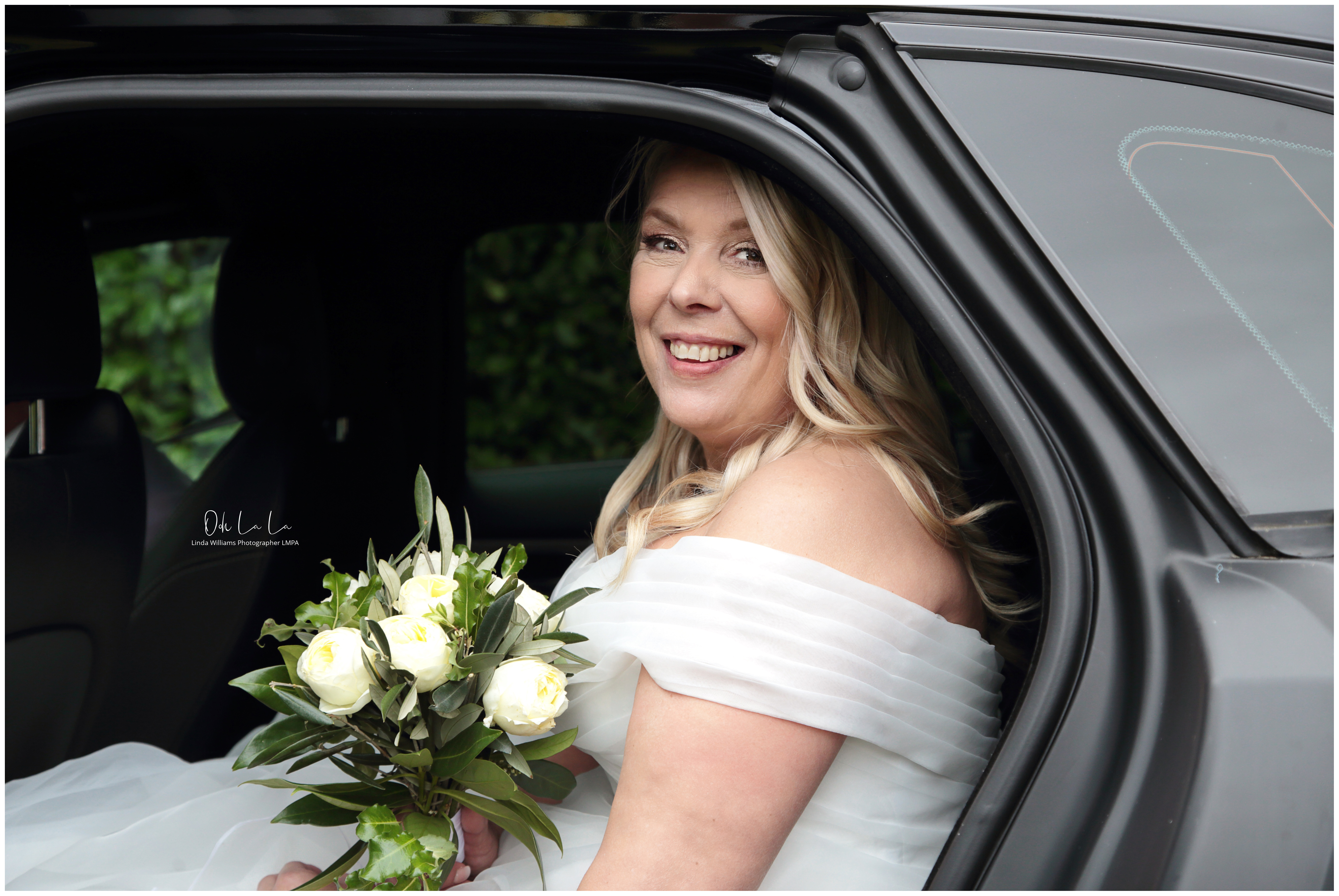 bride and bouquet in car