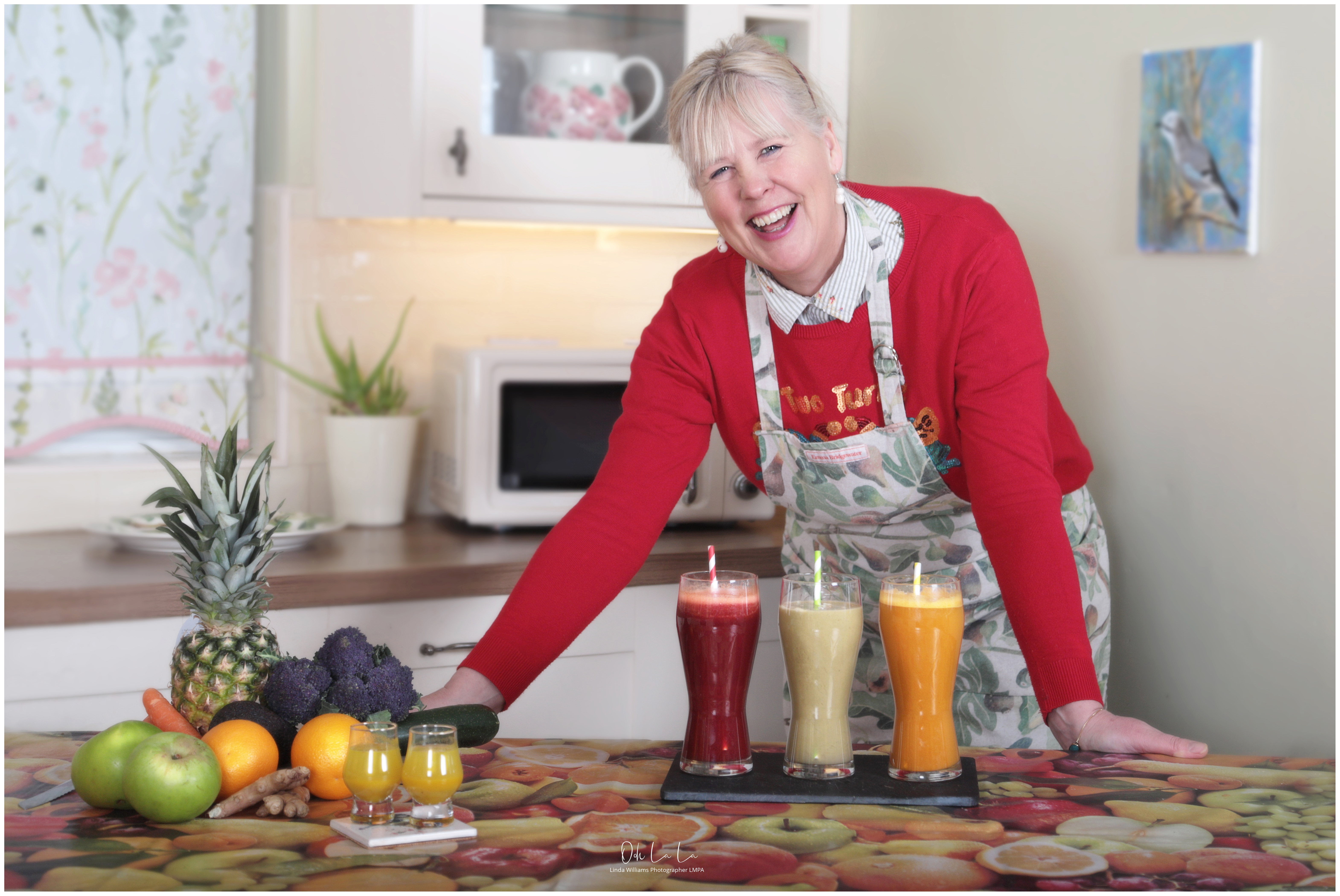 happy lady in kitchen preparing juices