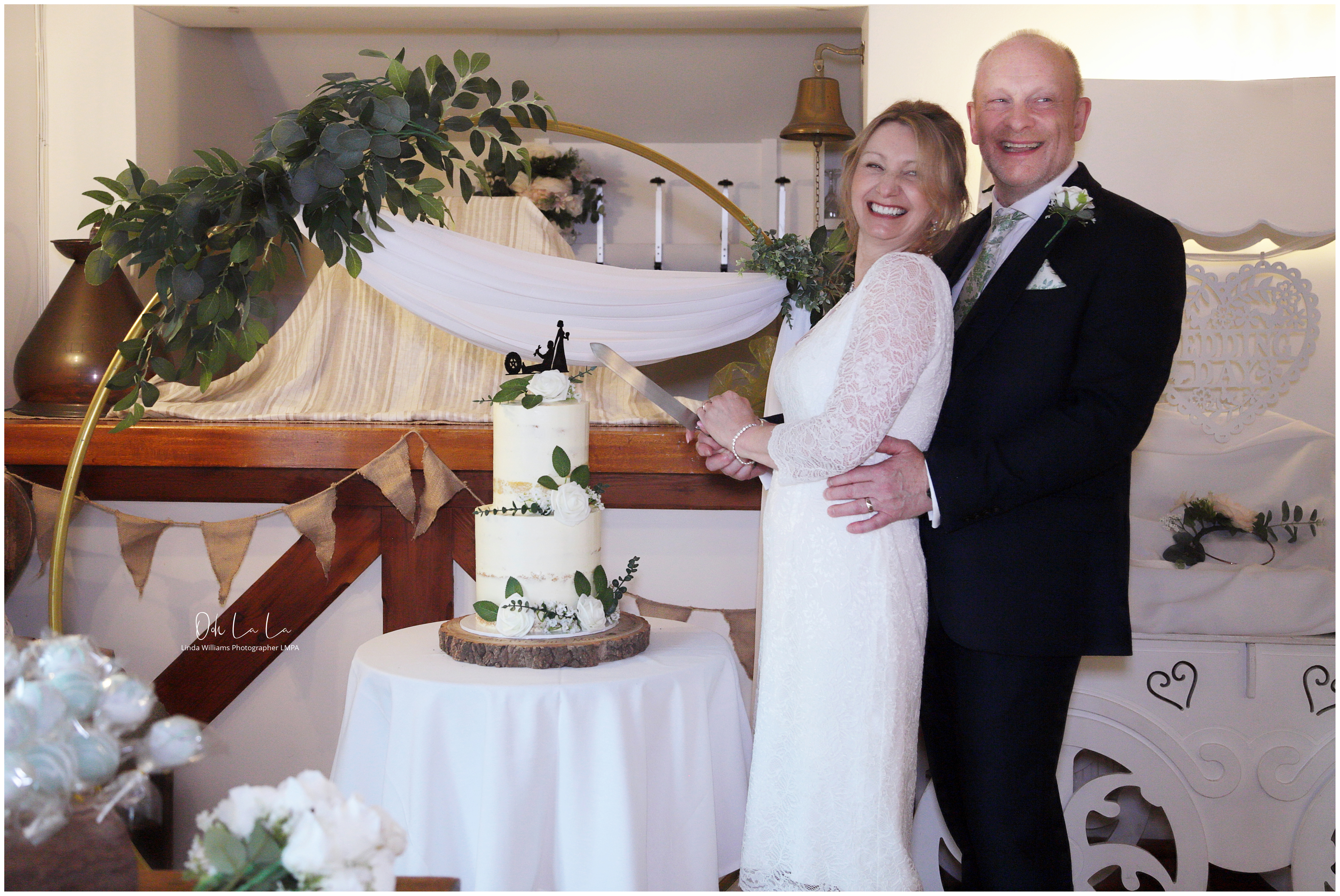 Bride and groom cutting wedding cake