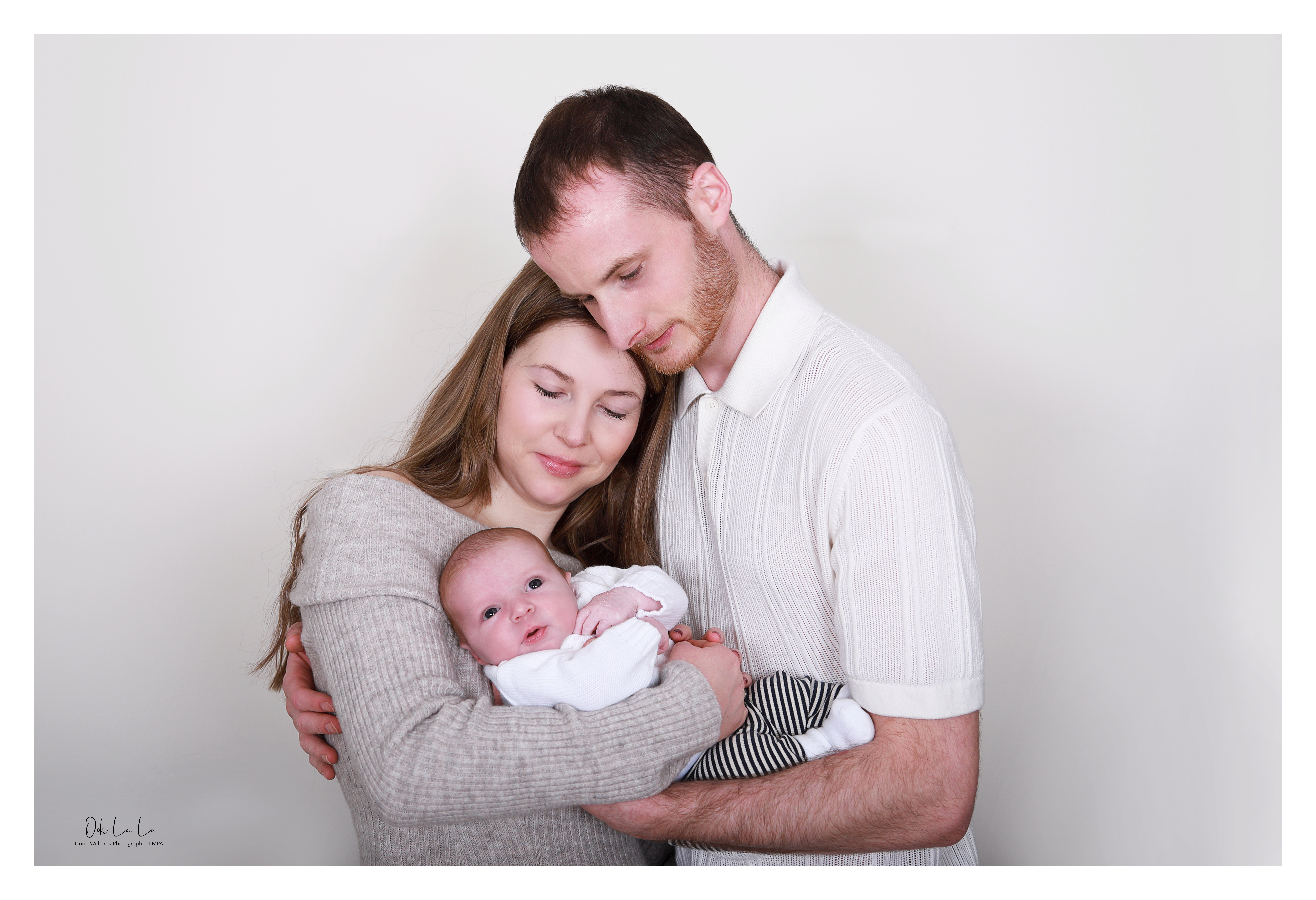 young couple looking at their newborn baby